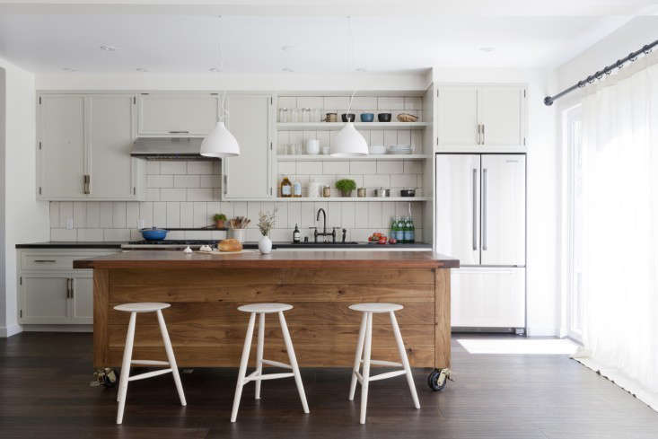 A Venice, California, kitchen by Simo Design features a wood-topped island and honed black granite countertops. See Rehab Diaries: LA Living, Venice Style for more views of the project. Photograph by David Gilbert for Simo Design.